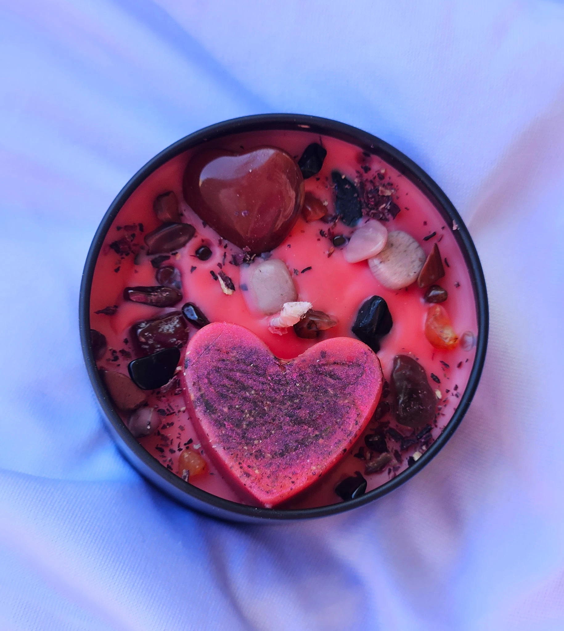 infused herb candle topside view with heart melt